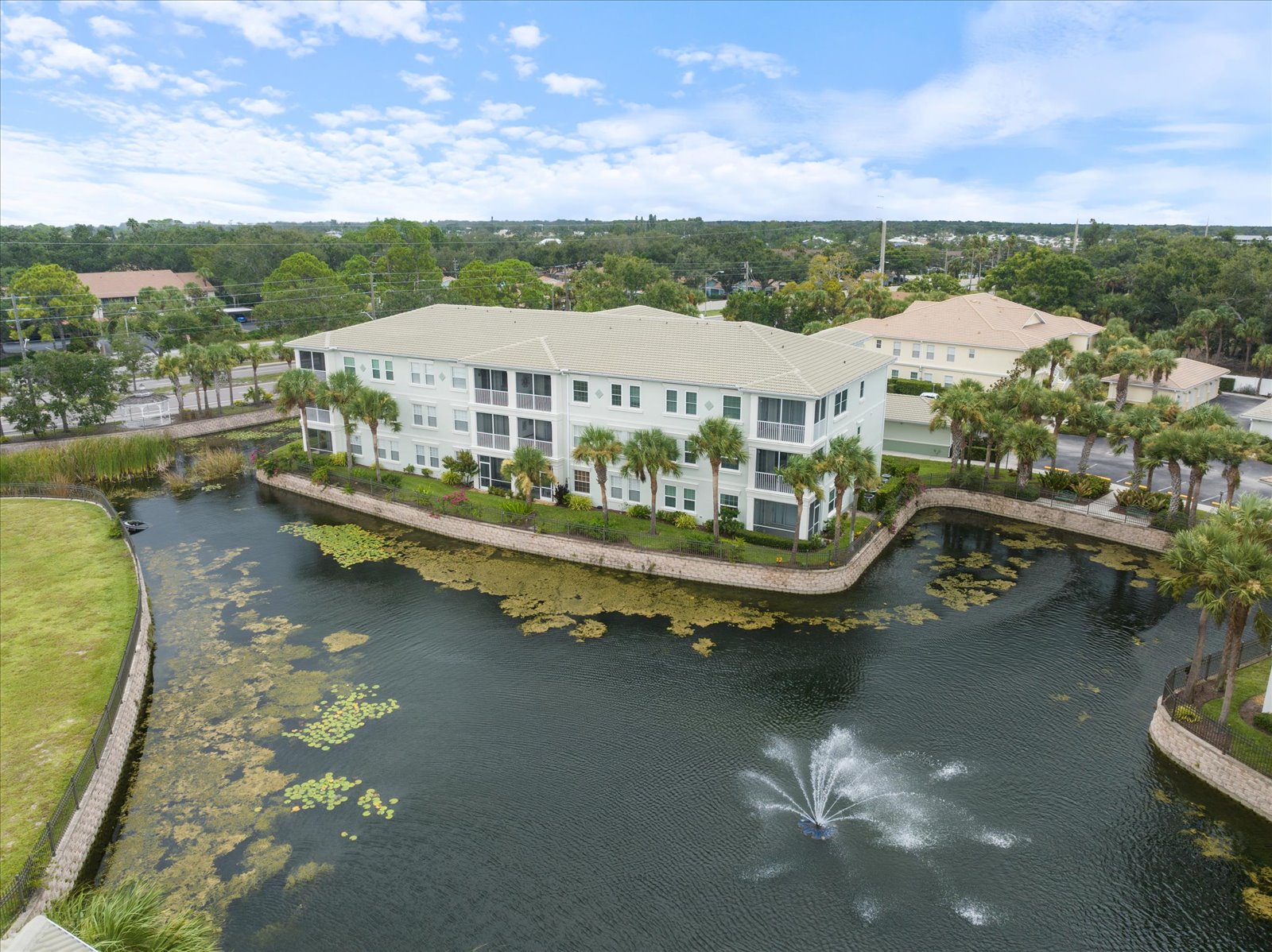 Aerial View Of Condo Building By Pond In Venice, Fl