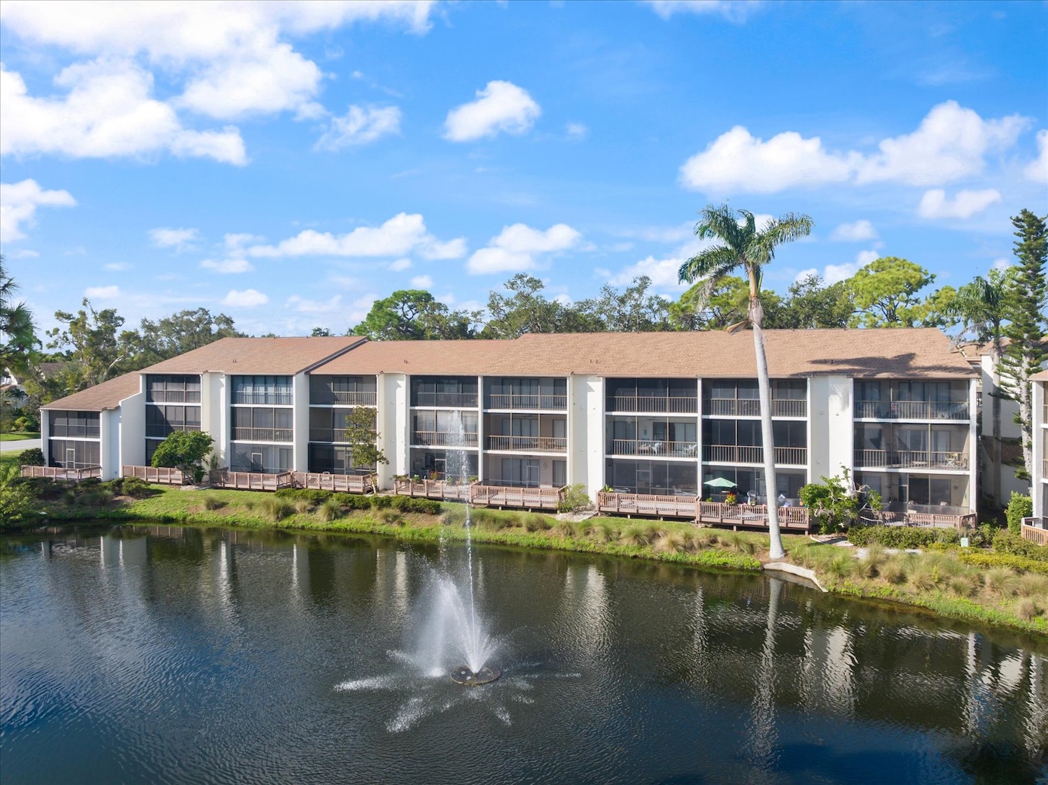 Condos In Venice, Florida With Palm Tree And Pond